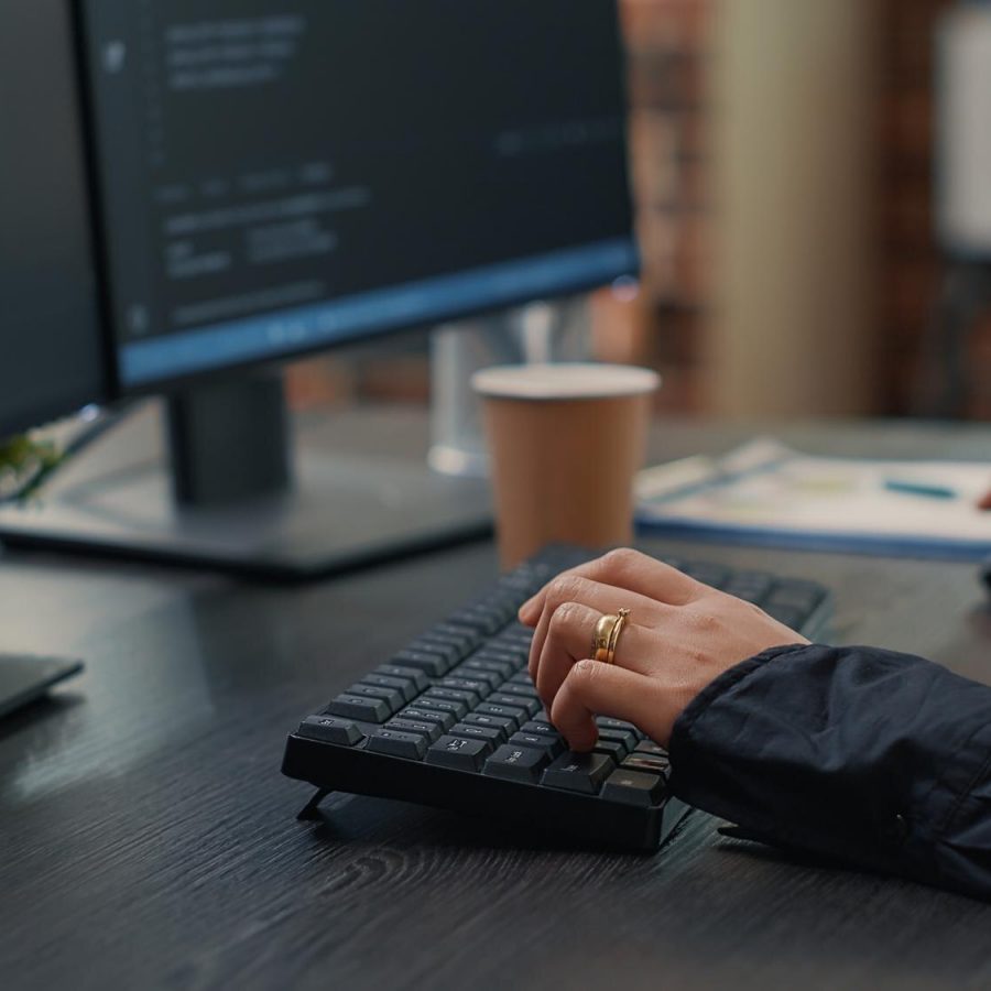 closeup-developer-hands-typing-code-keyboard-while-looking-computer-screens-with-programming-interface-software-programmer-sitting-desk-with-clipboard-writing-algorithm_482257-33551